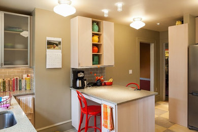 Mid-sized transitional l-shaped linoleum floor eat-in kitchen photo in Philadelphia with an undermount sink, flat-panel cabinets, light wood cabinets, quartz countertops, gray backsplash, ceramic backsplash, stainless steel appliances and an island