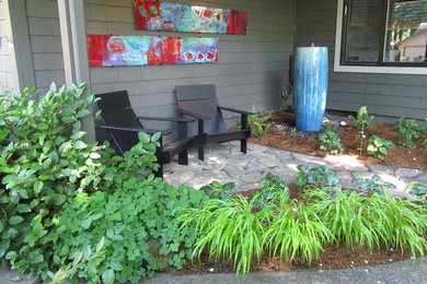 Mid-sized transitional stone porch idea in Portland with a roof extension