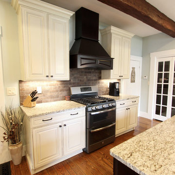 Painted Cream with Brown Glaze Cabinets with Giallo Granite Countertops ~ Sevill