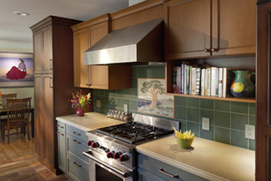 Eat-in kitchen - mid-sized farmhouse galley eat-in kitchen idea in San Francisco with recessed-panel cabinets, medium tone wood cabinets, stainless steel appliances and green backsplash