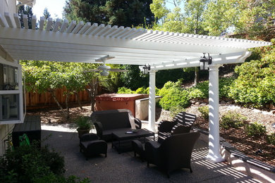 This is an example of a mid-sized backyard patio in Sacramento with a pergola.