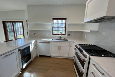 Inspiration for a mid-sized timeless u-shaped kitchen remodel in Cleveland with shaker cabinets, white cabinets and quartz countertops