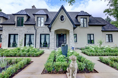 Example of a large transitional two-story exterior home design in Toronto