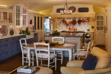 Open concept kitchen - mid-sized country single-wall dark wood floor and brown floor open concept kitchen idea in San Francisco with a farmhouse sink, recessed-panel cabinets, blue cabinets, multicolored backsplash, cement tile backsplash and an island