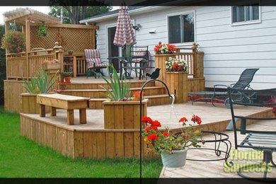 Inspiration for a large modern backyard deck remodel in Montreal