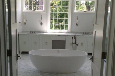 This is an example of a large contemporary master bathroom in Birmingham with recessed-panel cabinets, white cabinets, a freestanding tub, an alcove shower, gray tile, white tile, stone tile, white walls, marble floors, an undermount sink, marble benchtops and grey floor.