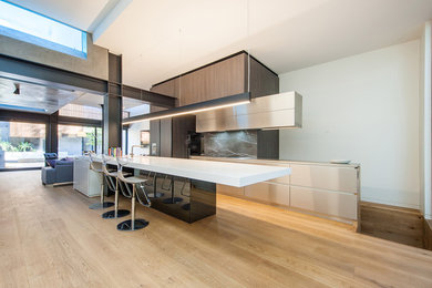 Inspiration for a transitional kitchen in Sydney with light hardwood floors.