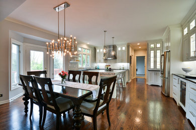Kitchen/dining room combo - large transitional dark wood floor and brown floor kitchen/dining room combo idea in Chicago with gray walls and no fireplace
