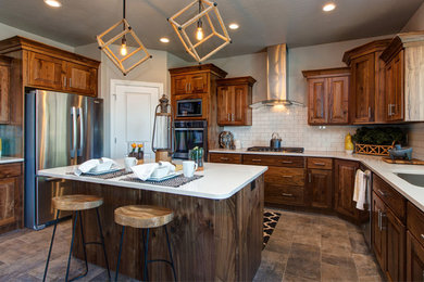 Eat-in kitchen - large craftsman u-shaped ceramic tile eat-in kitchen idea in Salt Lake City with a farmhouse sink, raised-panel cabinets, medium tone wood cabinets, quartzite countertops, white backsplash, ceramic backsplash, stainless steel appliances and an island