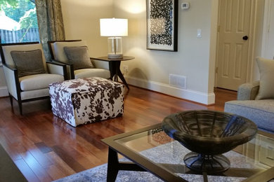 Mid-sized transitional medium tone wood floor and brown floor family room photo in Other with beige walls