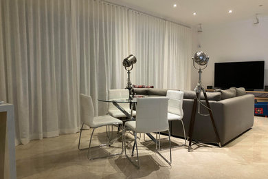 Living room - mid-sized modern open concept travertine floor living room idea in Miami with beige walls and a tv stand