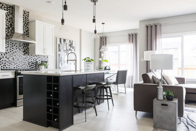Inspiration for a mid-sized contemporary l-shaped open plan kitchen in Edmonton with an undermount sink, shaker cabinets, white cabinets, quartz benchtops, multi-coloured splashback, ceramic splashback, stainless steel appliances, laminate floors, with island, white benchtop and beige floor.