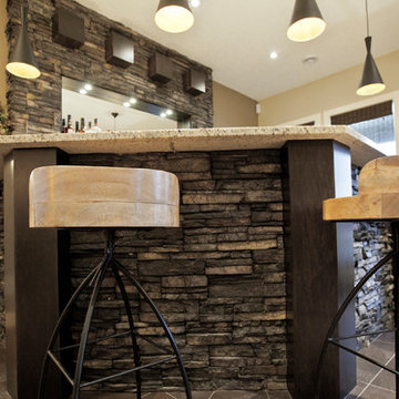 Pioneering Exquisite DesignStone basement wetbar and dark wood cabinetry
