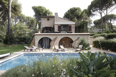 Идея дизайна: двухэтажный, бежевый частный загородный дом в средиземноморском стиле с облицовкой из цементной штукатурки, двускатной крышей, черепичной крышей и коричневой крышей