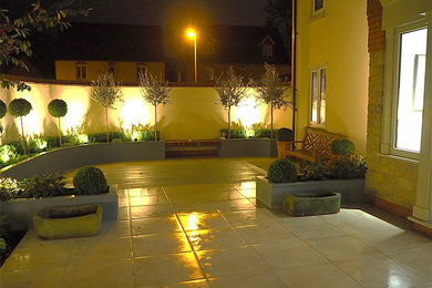 This is an example of a mid-sized modern backyard partial sun garden in Buckinghamshire.