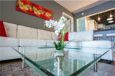 Inspiration for a mid-sized transitional enclosed dark wood floor and brown floor living room remodel in Orlando with gray walls