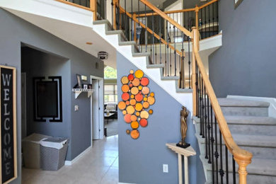 Staircase - mid-sized contemporary carpeted curved mixed material railing staircase idea in New York with carpeted risers