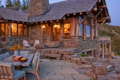 This is an example of a country patio in Other with natural stone pavers and no cover.