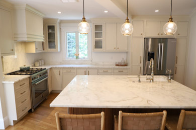 Inspiration for a small transitional light wood floor kitchen remodel in Boston with an undermount sink, beaded inset cabinets, beige cabinets, marble countertops, stainless steel appliances, an island and white countertops
