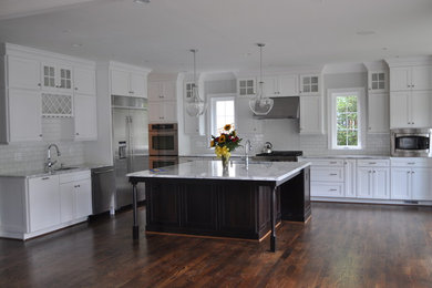 Eat-in kitchen - traditional eat-in kitchen idea in DC Metro with quartzite countertops, white backsplash, subway tile backsplash and an island