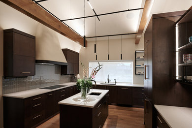 Kitchen - large scandinavian light wood floor, brown floor and vaulted ceiling kitchen idea in Denver with a drop-in sink, flat-panel cabinets, brown cabinets, quartz countertops, green backsplash, glass tile backsplash, paneled appliances, two islands and white countertops