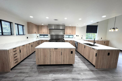 Eat-in kitchen - modern u-shaped vinyl floor and gray floor eat-in kitchen idea in Sacramento with an undermount sink, flat-panel cabinets, light wood cabinets, quartz countertops, white backsplash, quartz backsplash, stainless steel appliances, an island and white countertops