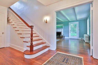 Example of a mid-sized classic dark wood floor foyer design in New York