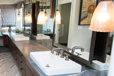 Inspiration for a large rustic master gray tile and stone slab brick floor and gray floor bathroom remodel in Phoenix with shaker cabinets, distressed cabinets, a one-piece toilet, gray walls, a vessel sink, soapstone countertops and a hinged shower door