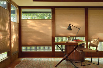 Inspiration for a mid-sized contemporary freestanding desk medium tone wood floor study room remodel in Orange County with beige walls