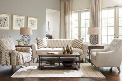 Inspiration for a mid-sized transitional formal and enclosed dark wood floor and brown floor living room remodel in Charlotte with gray walls, no fireplace and no tv
