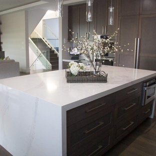 Large modern kitchen pantry appliance - Inspiration for a large modern l-shaped kitchen pantry remodel in Vancouver with an undermount sink, shaker cabinets, white cabinets, quartz countertops, white backsplash, stone tile backsplash, stainless steel appliances and an island