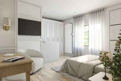 This is an example of a medium sized modern guest bedroom in Manchester with white walls, light hardwood flooring, panelled walls and feature lighting.