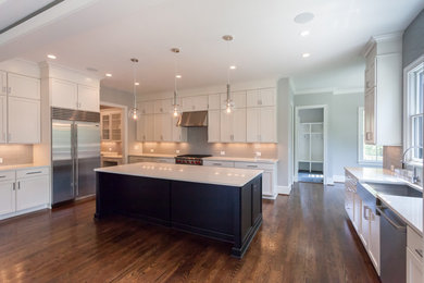 Eat-in kitchen - large contemporary l-shaped medium tone wood floor and brown floor eat-in kitchen idea in DC Metro with a farmhouse sink, shaker cabinets, white cabinets, granite countertops, white backsplash, porcelain backsplash, stainless steel appliances, an island and white countertops