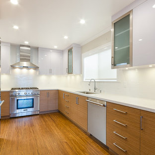 Design ideas for a medium sized modern u-shaped enclosed kitchen in San Francisco with a submerged sink, flat-panel cabinets, white cabinets, white splashback, stainless steel appliances, light hardwood flooring, no island, engineered stone countertops and beige floors.