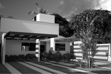 Imagen de fachada de casa multicolor rústica de tamaño medio de dos plantas con revestimiento de piedra y tejado plano