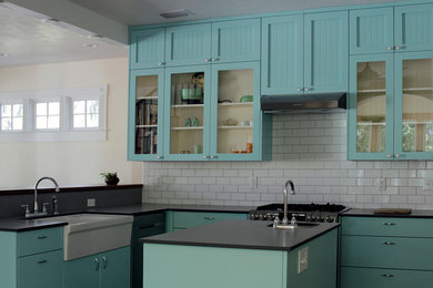 Inspiration for a large country l-shaped eat-in kitchen remodel in Jacksonville with glass-front cabinets, an island, a farmhouse sink, blue cabinets, soapstone countertops, white backsplash and subway tile backsplash
