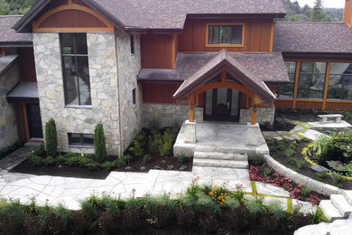 Photo of a modern front yard full sun formal garden for summer in Montreal with with pond and natural stone pavers.
