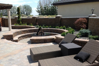 Patio - mid-sized mediterranean backyard stone patio idea in Other with no cover