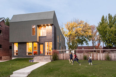 Inspiration for a large modern two-storey house exterior in St Louis with mixed siding.