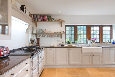 Inspiration for an expansive country l-shaped open plan kitchen in Edinburgh with a farmhouse sink, shaker cabinets, white cabinets, granite benchtops, panelled appliances, ceramic floors and no island.