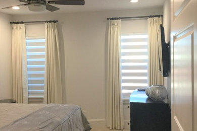Contemporary bedroom in Orlando with beige walls.