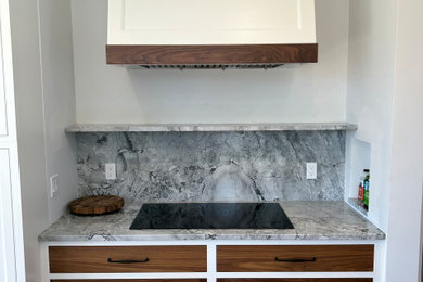 Example of a large classic kitchen design in Boston with shaker cabinets and an island