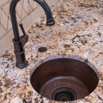 Hammered copper sink coordinates with the hammered copper accents on the vent.