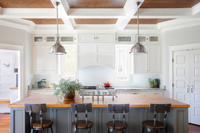 Open concept kitchen - mid-sized traditional l-shaped coffered ceiling open concept kitchen idea in Other with beaded inset cabinets, white cabinets, wood countertops and an island