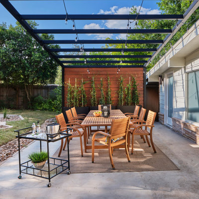 Mid-sized 1950s backyard concrete patio photo in Austin