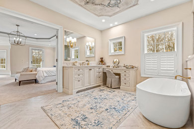Inspiration for a huge timeless master light wood floor and beige floor bathroom remodel in Cleveland with recessed-panel cabinets, beige cabinets, beige walls, an undermount sink, marble countertops, a hinged shower door and beige countertops