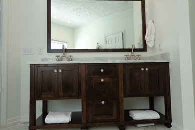 Freestanding bathtub - large traditional master gray tile, white tile and porcelain tile porcelain tile freestanding bathtub idea in Raleigh with recessed-panel cabinets, dark wood cabinets, marble countertops, a two-piece toilet, white walls and an undermount sink