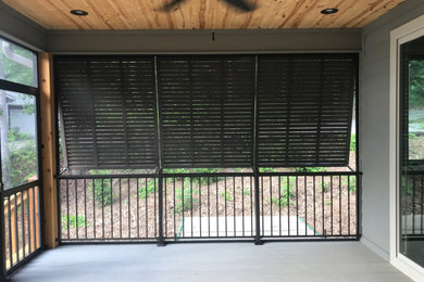 Inspiration for a mid-sized craftsman screened-in back porch remodel in Other with decking