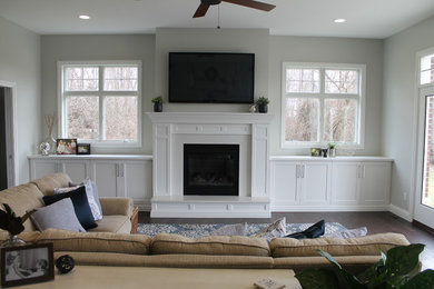 Large trendy open concept living room photo in Other with gray walls, a standard fireplace, a stone fireplace and a wall-mounted tv
