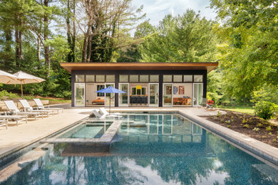 Pool house - large 1960s backyard rectangular pool house idea in Wilmington